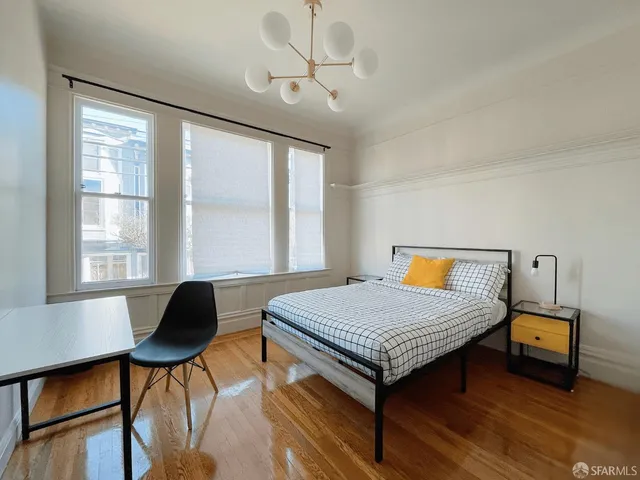 a bedroom with furniture and a window