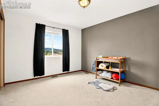 an empty room with windows and closet