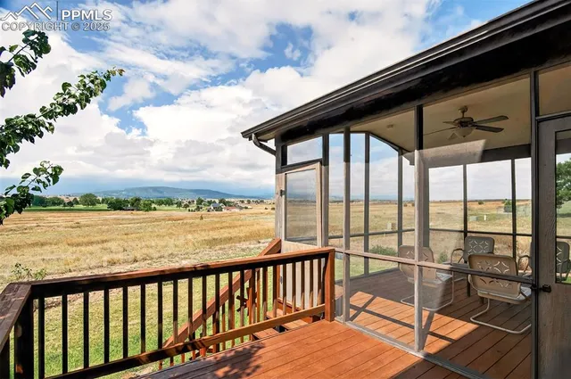 a view of backyard of house with green space