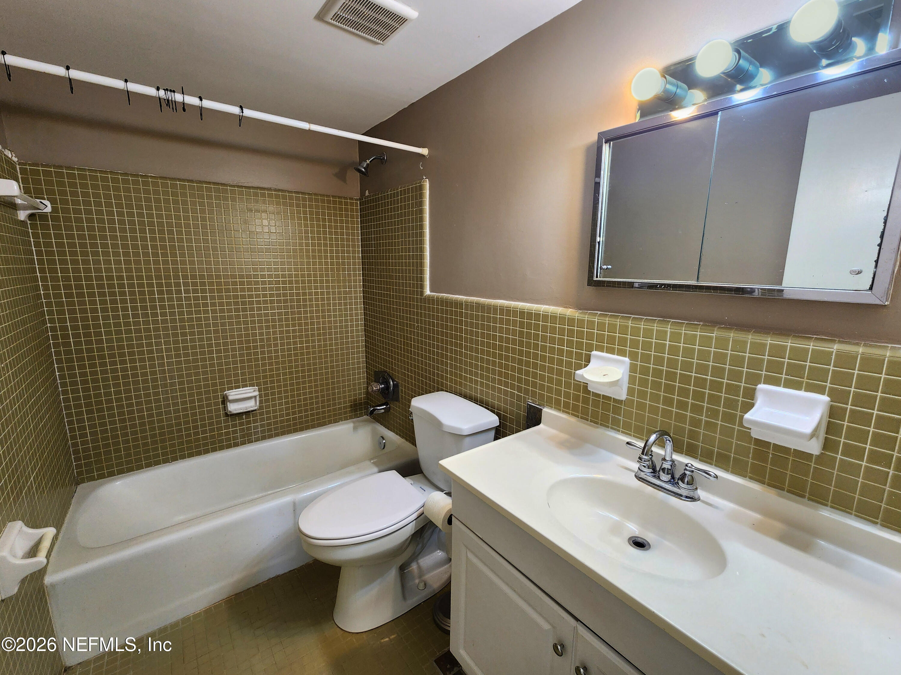 1716 El Camino Road, Unit 1 Jacksonville, FL 32216 - Photo 11 of 15 a bathroom with a sink toilet and shower