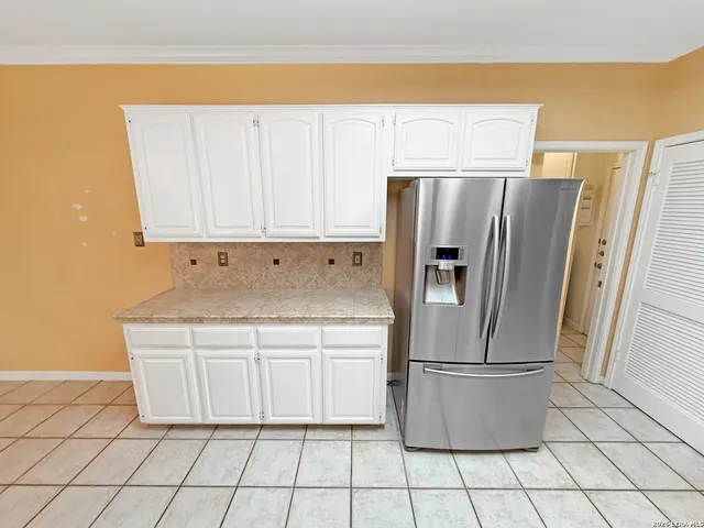 a view of a room with a sink and cabinets
