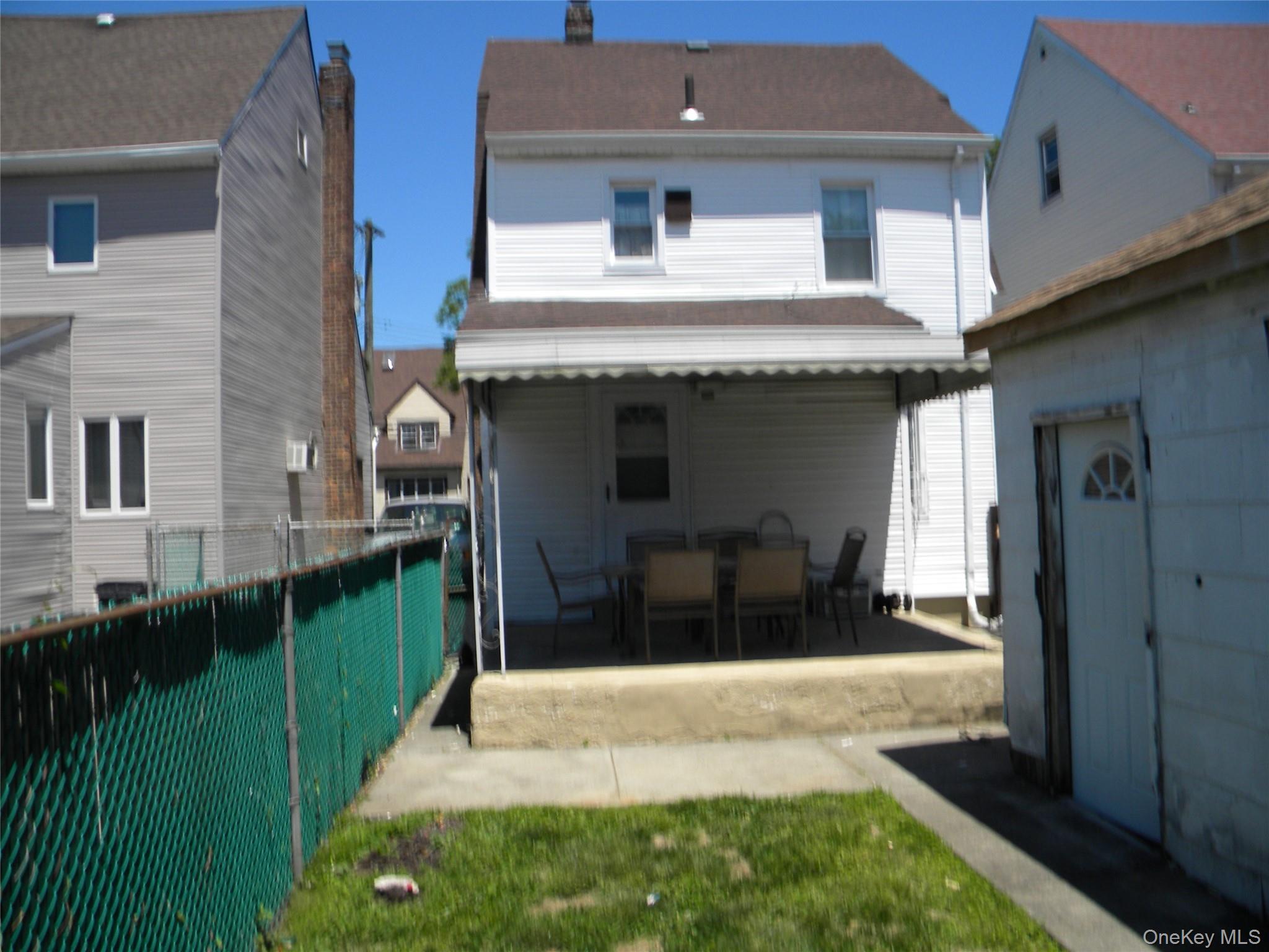 241-26 86th Road Queens, NY 11426 - Photo 34 of 38 a front view of a house with a yard