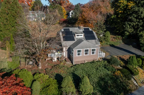 an aerial view of a house with a yard