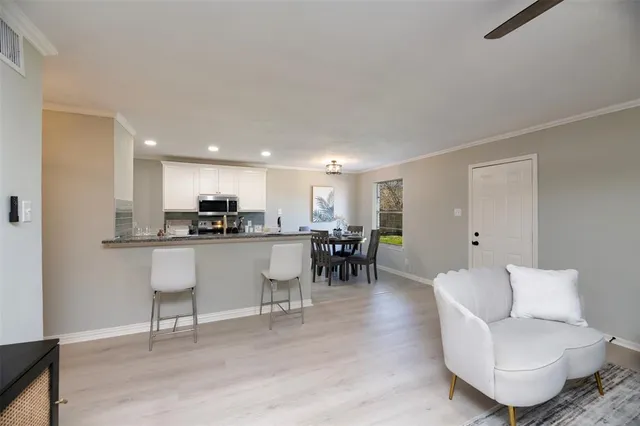 a living room with furniture a dining table and a sink