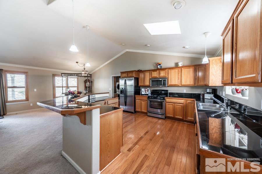 200 Antelope Valley Road Reno, NV 89506 - Photo 11 of 28 a kitchen with stainless steel appliances kitchen island granite countertop a stove refrigerator and cabinets