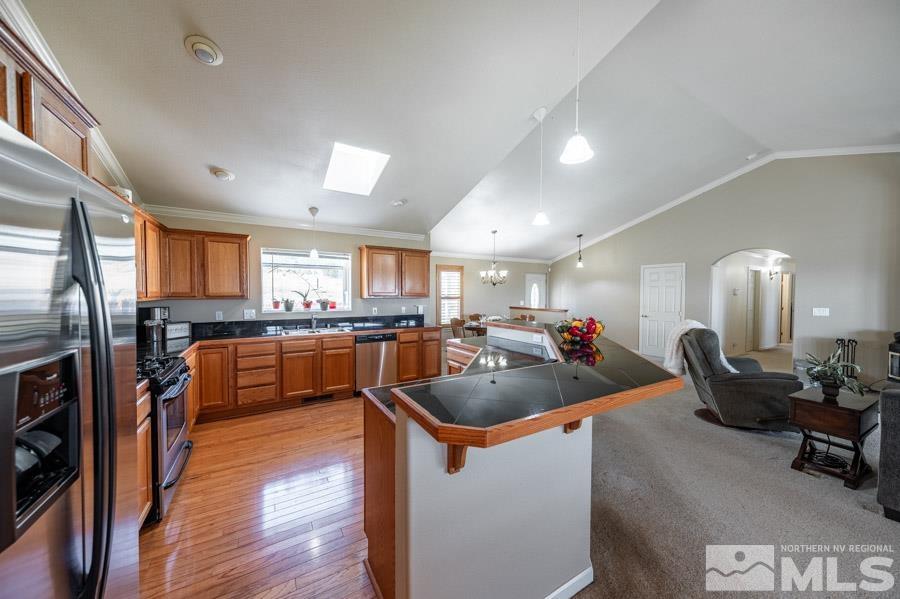 200 Antelope Valley Road Reno, NV 89506 - Photo 12 of 28 a kitchen with stainless steel appliances granite countertop a refrigerator a sink a stove and a wooden floors