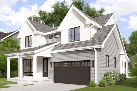 a view of a white house with a small yard and potted plants