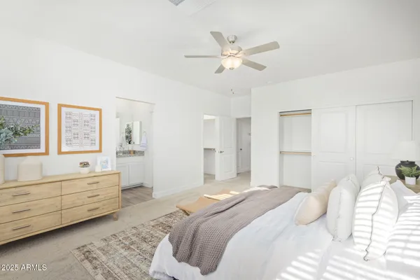 a bedroom with a large bed and a chandelier