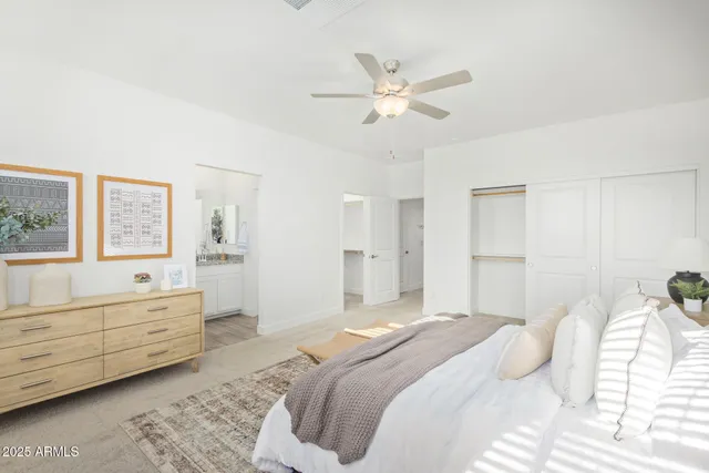 a bedroom with a large bed and a chandelier