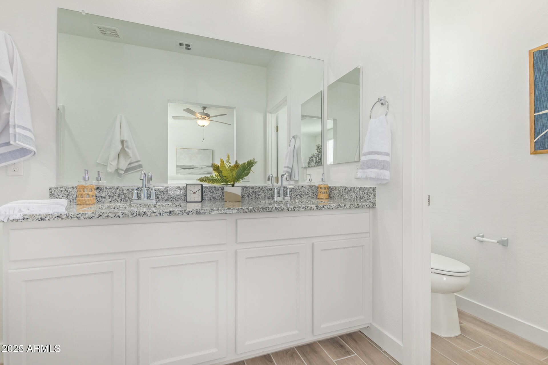 3230 East Thomas Road, Unit 112 Mesa, AZ 85213 - Photo 16 of 32 a bathroom with a granite countertop sink and a mirror