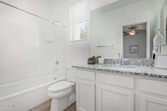 an empty room with a ceiling fan and a window