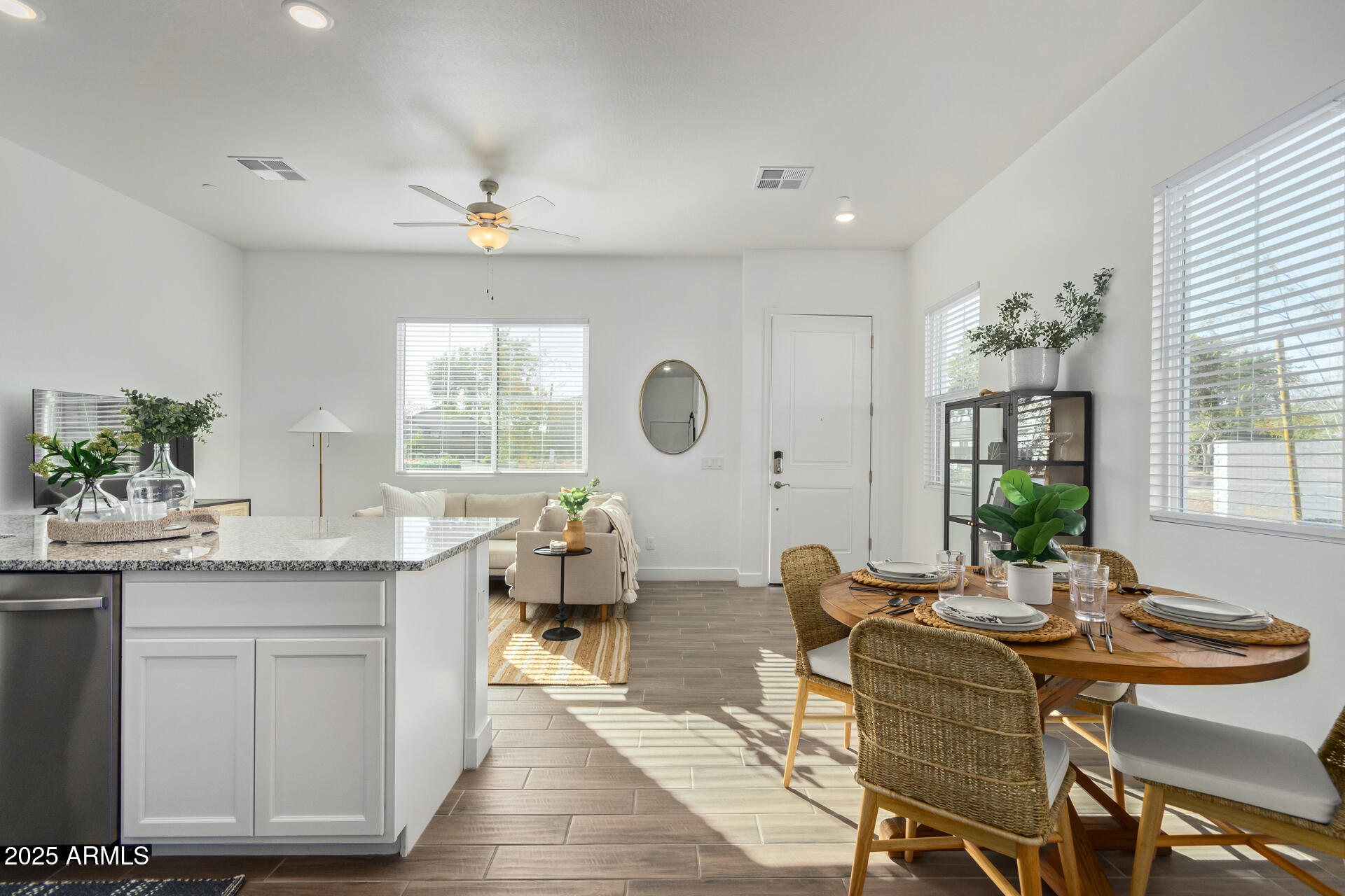 3230 East Thomas Road, Unit 112 Mesa, AZ 85213 - Photo 2 of 32 a living room with granite countertop furniture a potted plant a sink and a large window