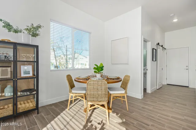 a living room with granite countertop furniture a potted plant a sink and a large window
