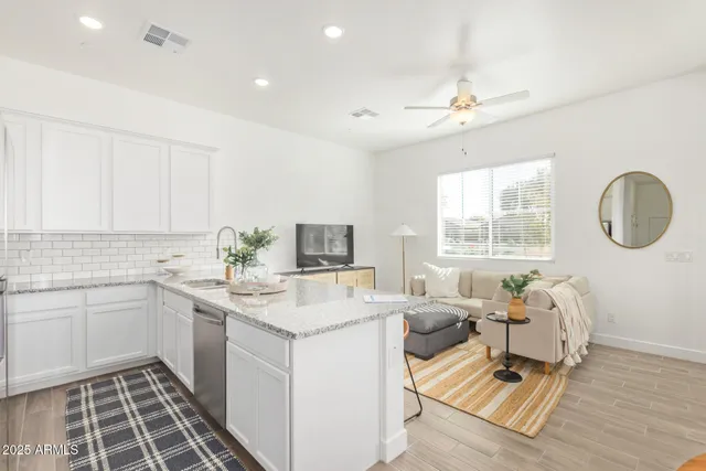a living room with lots of furniture and a large window