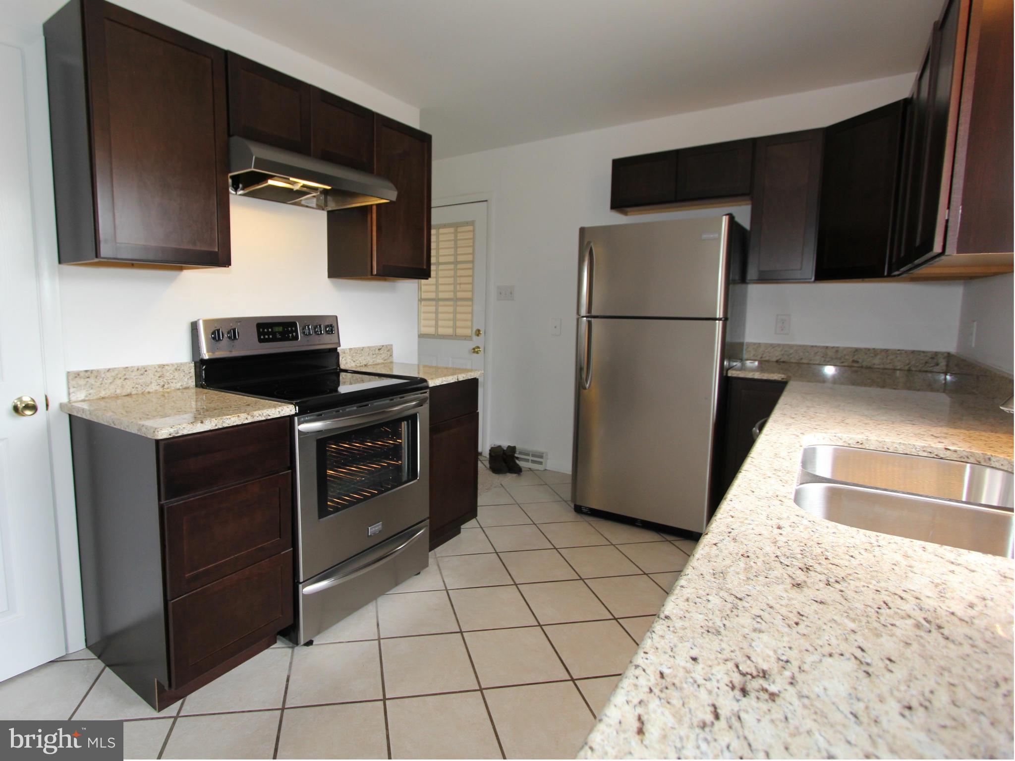 5047 Shookstown Road Frederick, MD 21702 - Photo 2 of 30 a kitchen with a refrigerator and a sink