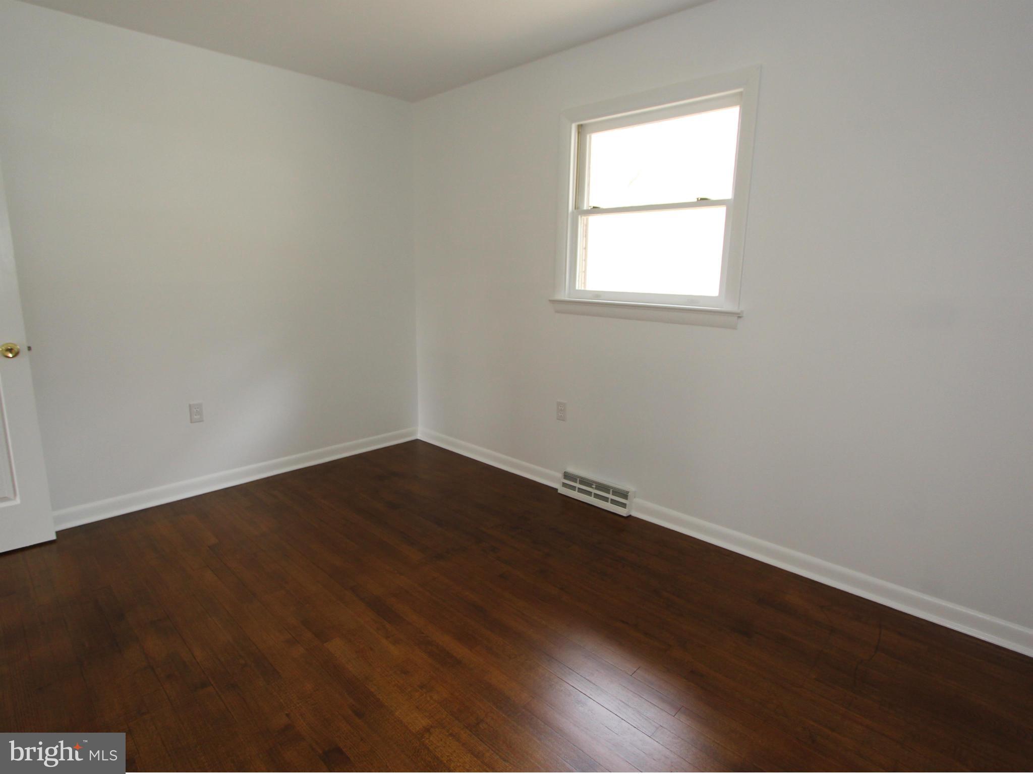 5047 Shookstown Road Frederick, MD 21702 - Photo 11 of 30 an empty room with wooden floor and windows