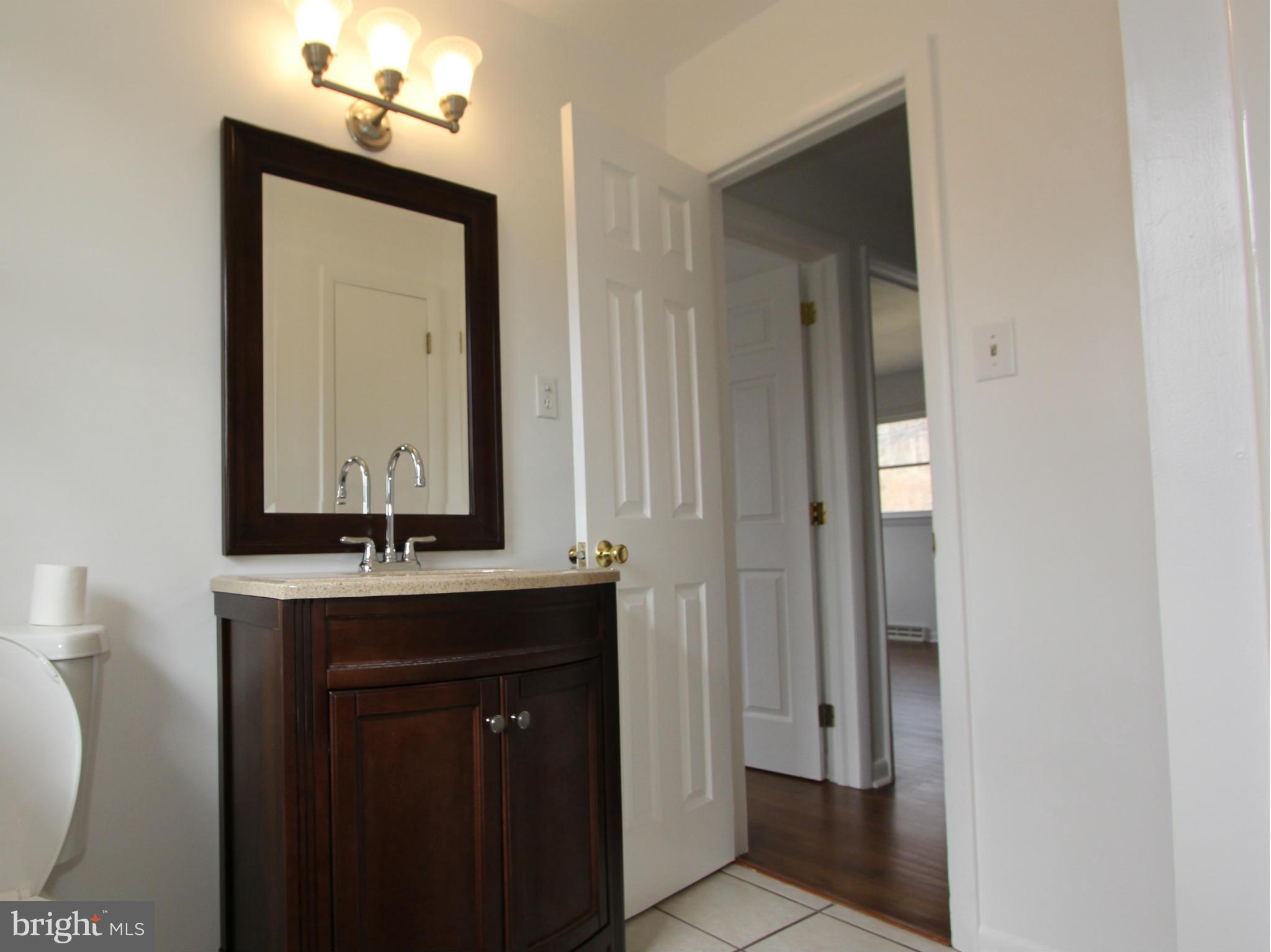 5047 Shookstown Road Frederick, MD 21702 - Photo 12 of 30 a bathroom with a sink a toilet and mirror