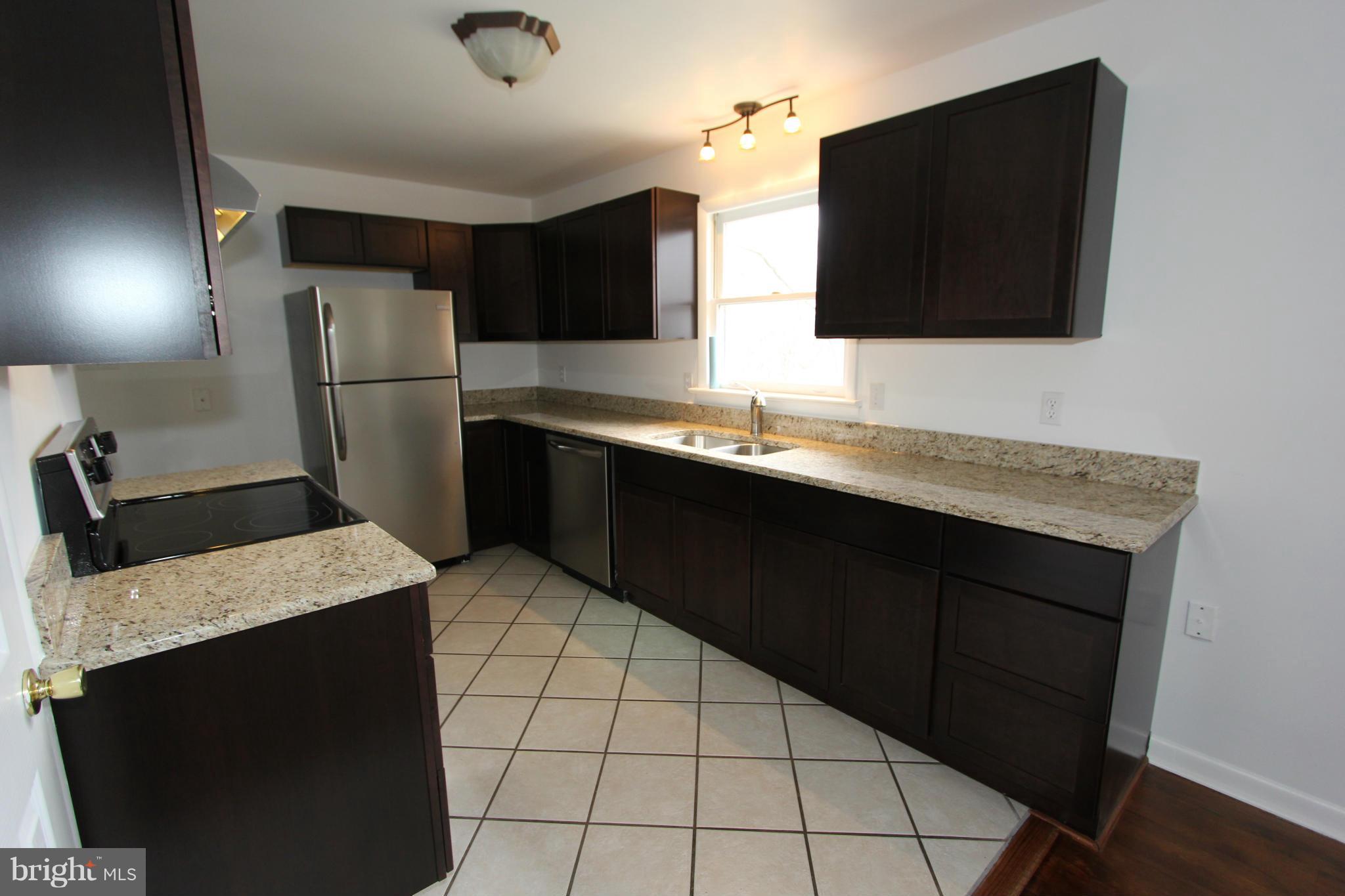 5047 Shookstown Road Frederick, MD 21702 - Photo 3 of 30 a kitchen with a sink and a refrigerator