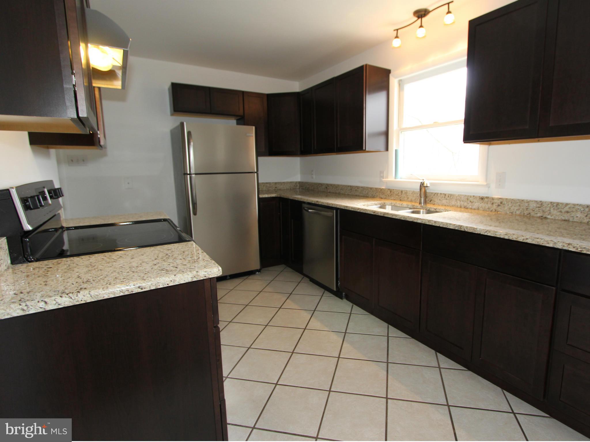 5047 Shookstown Road Frederick, MD 21702 - Photo 4 of 30 a kitchen with stainless steel appliances a sink refrigerator and microwave