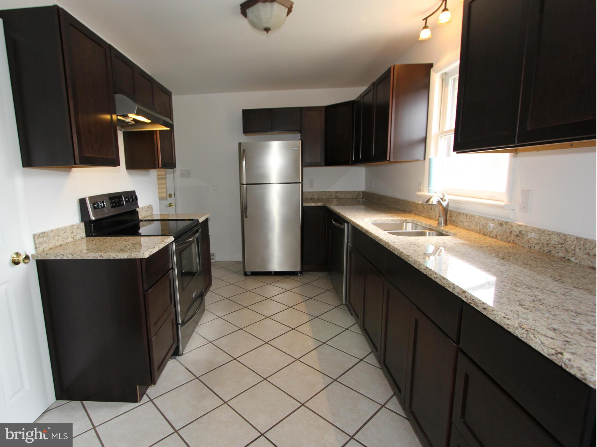 5047 Shookstown Road Frederick, MD 21702 - Photo 5 of 30 a kitchen with stainless steel appliances granite countertop a sink stove and refrigerator