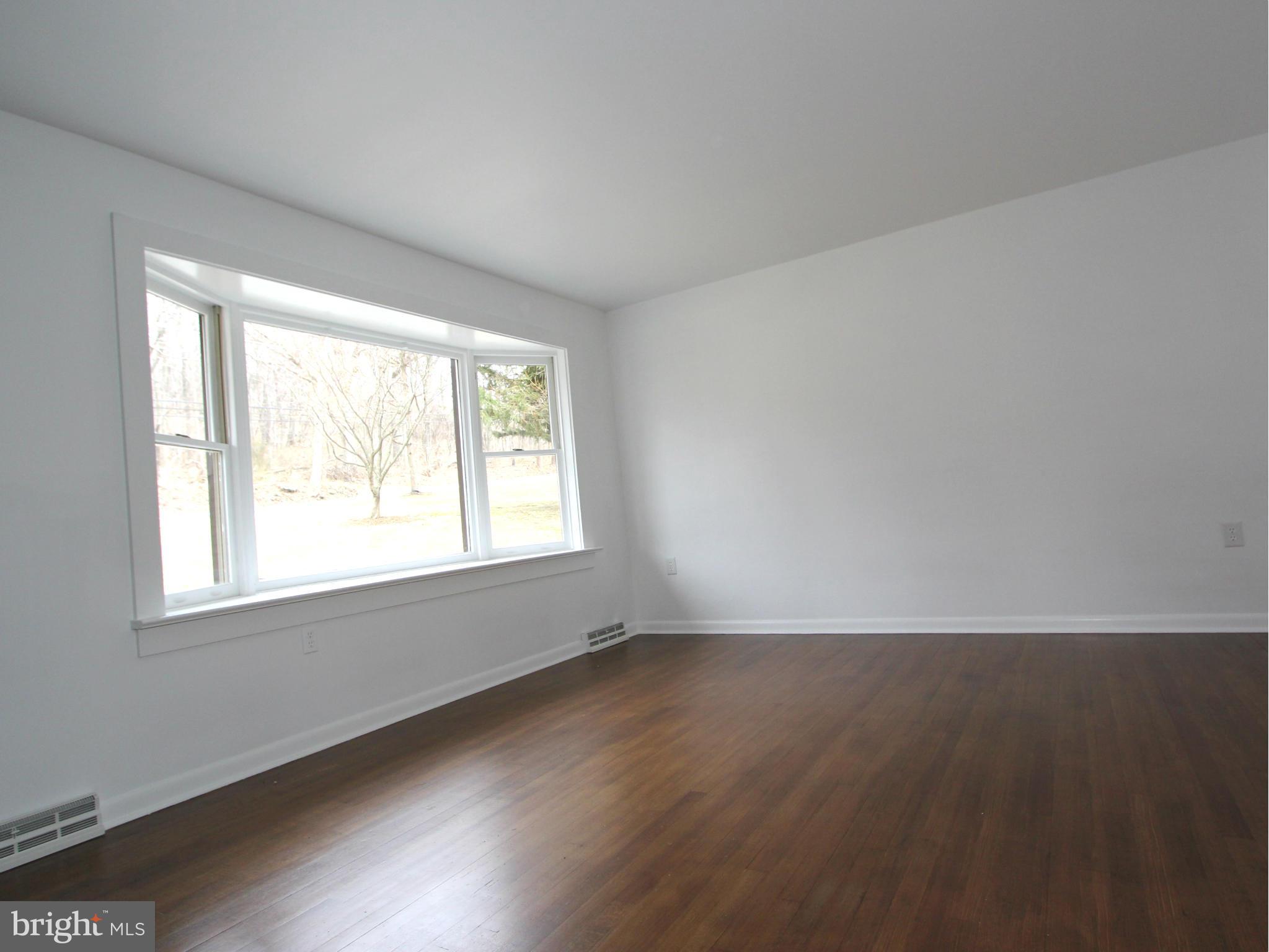 5047 Shookstown Road Frederick, MD 21702 - Photo 7 of 30 an empty room with wooden floor and windows