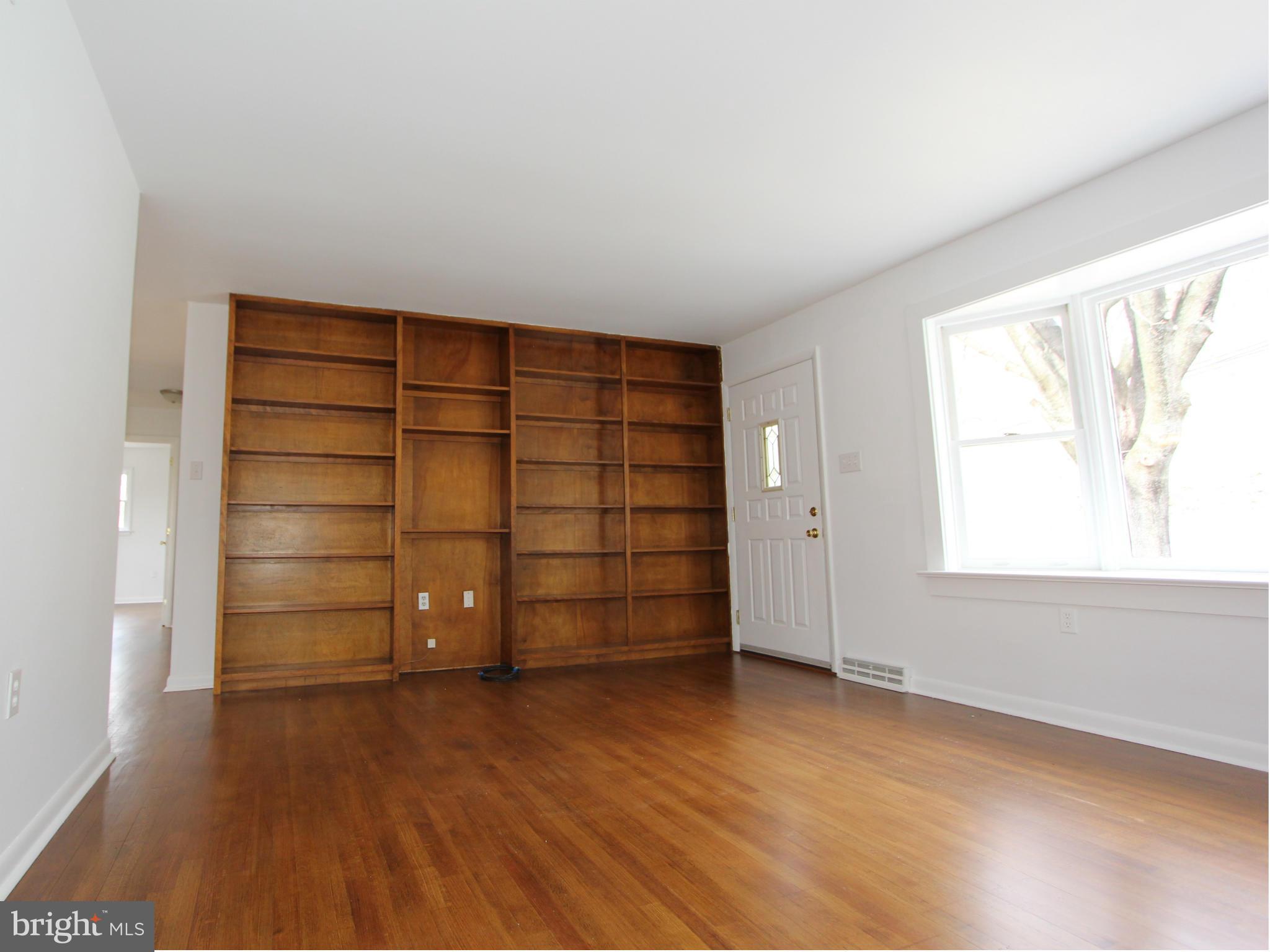 5047 Shookstown Road Frederick, MD 21702 - Photo 8 of 30 an empty room with a wooden cabinet and door