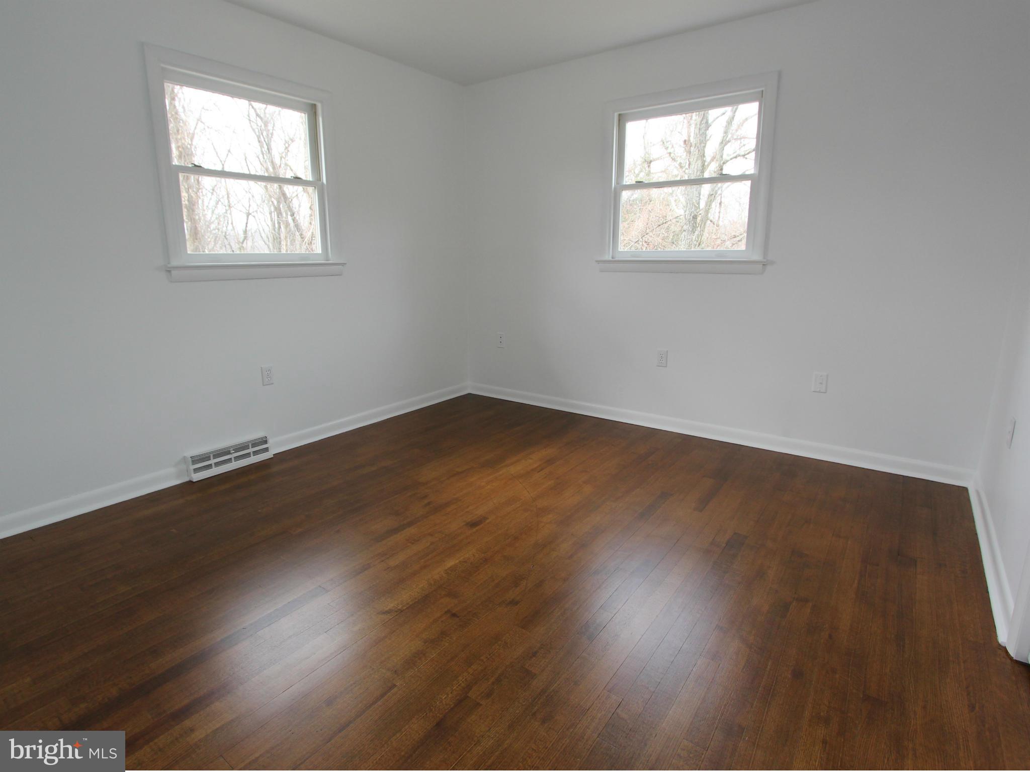 5047 Shookstown Road Frederick, MD 21702 - Photo 9 of 30 an empty room with wooden floor and windows
