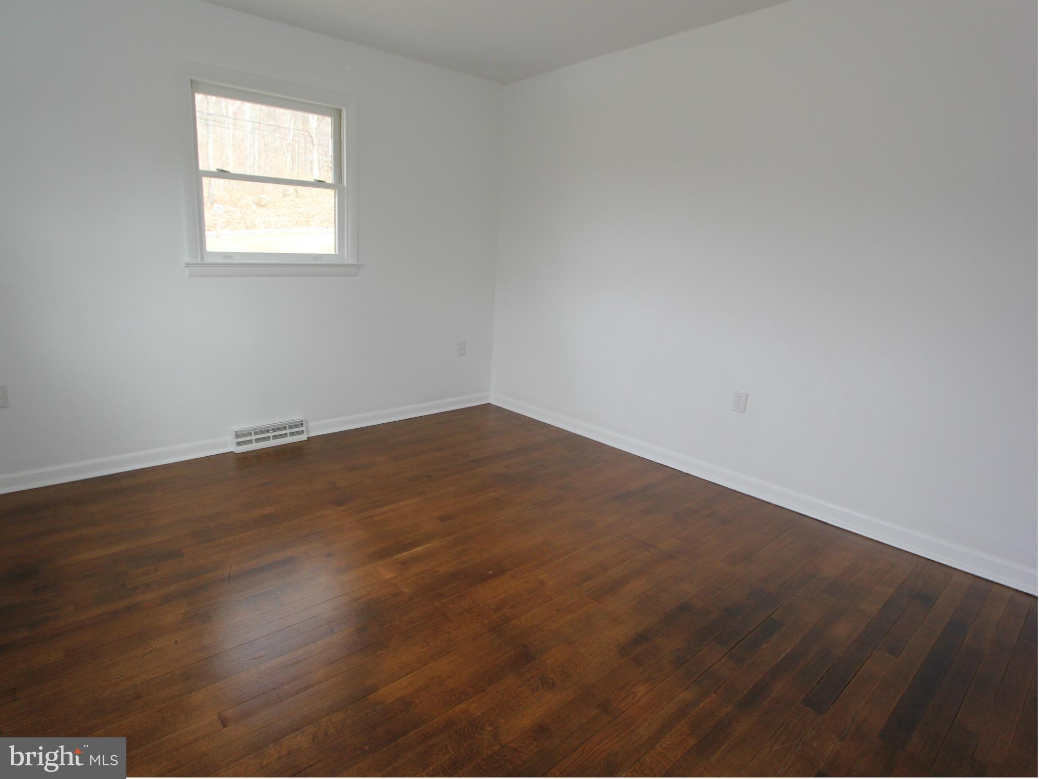 5047 Shookstown Road Frederick, MD 21702 - Photo 10 of 30 an empty room with wooden floor and windows