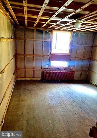 a view of room with wooden floor