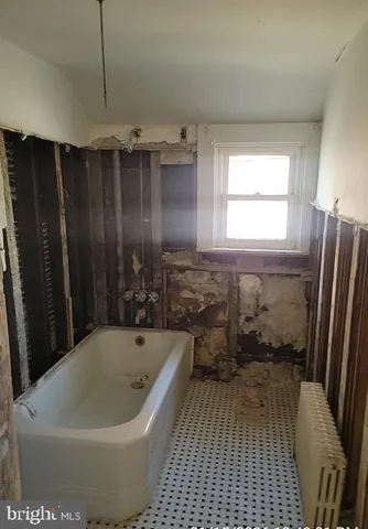 a bathroom with a bathtub and shower