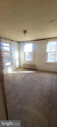 an empty room with a empty space and windows
