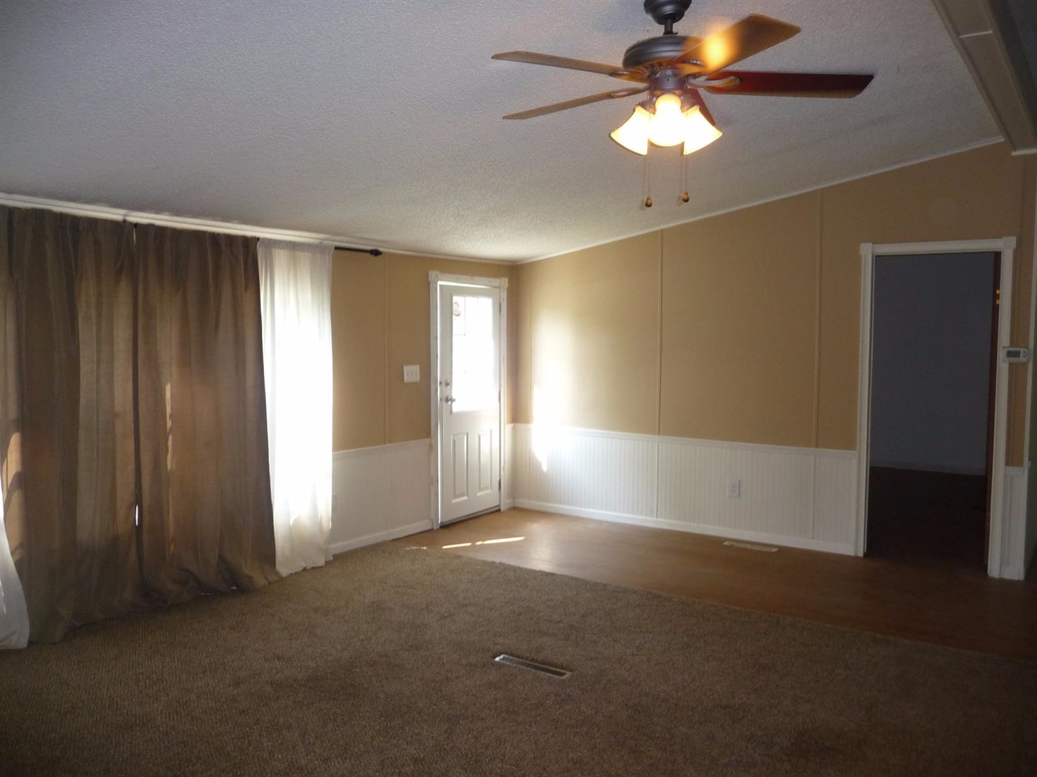 11889 Old Colony Road Demotte, IN 46310 - Photo 6 of 10 en empty room with windows and fan