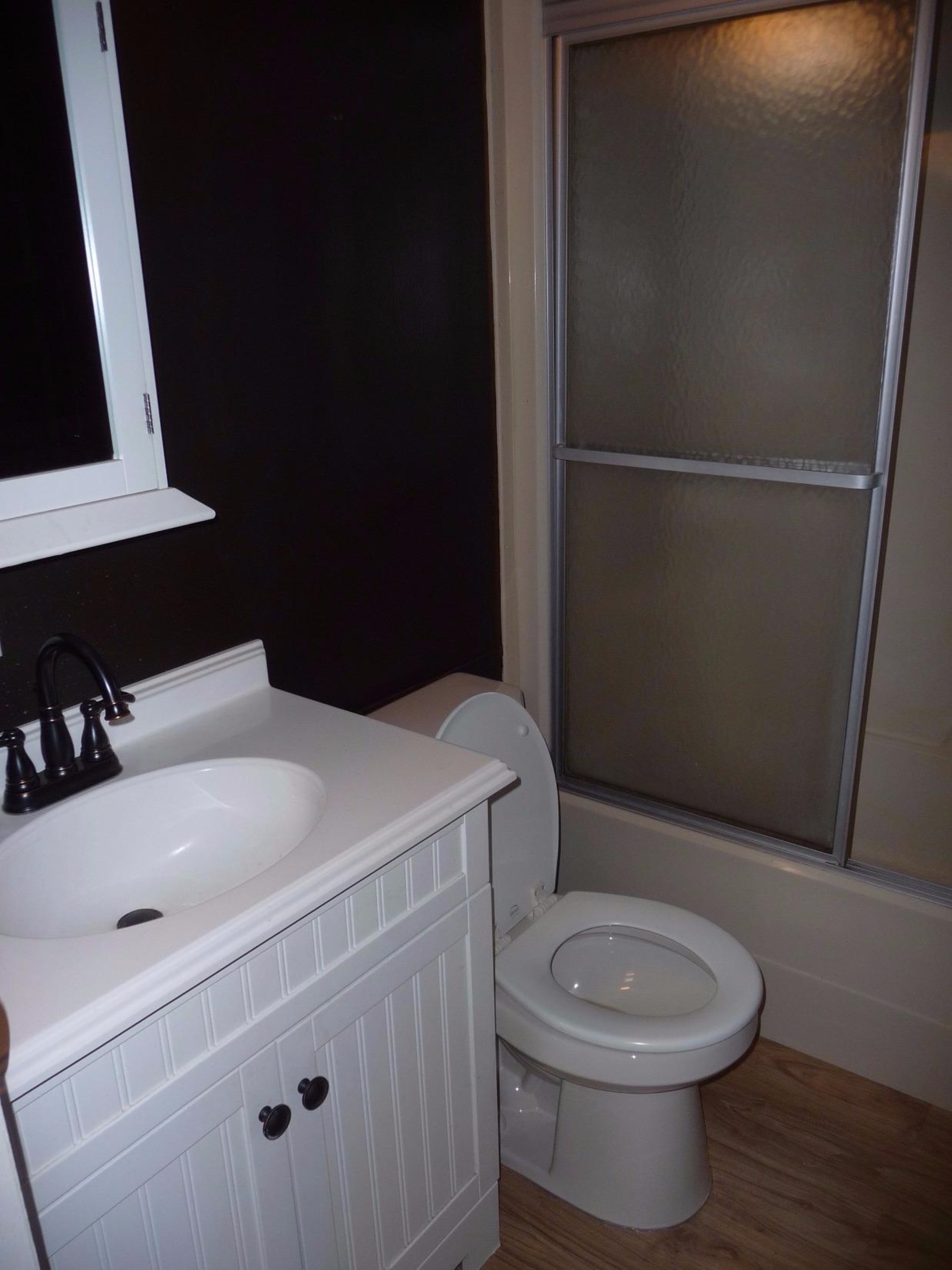 11889 Old Colony Road Demotte, IN 46310 - Photo 9 of 10 a bathroom with a sink a toilet and vanity