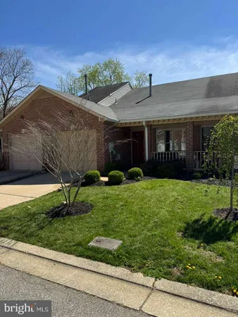 a front view of house with a garden