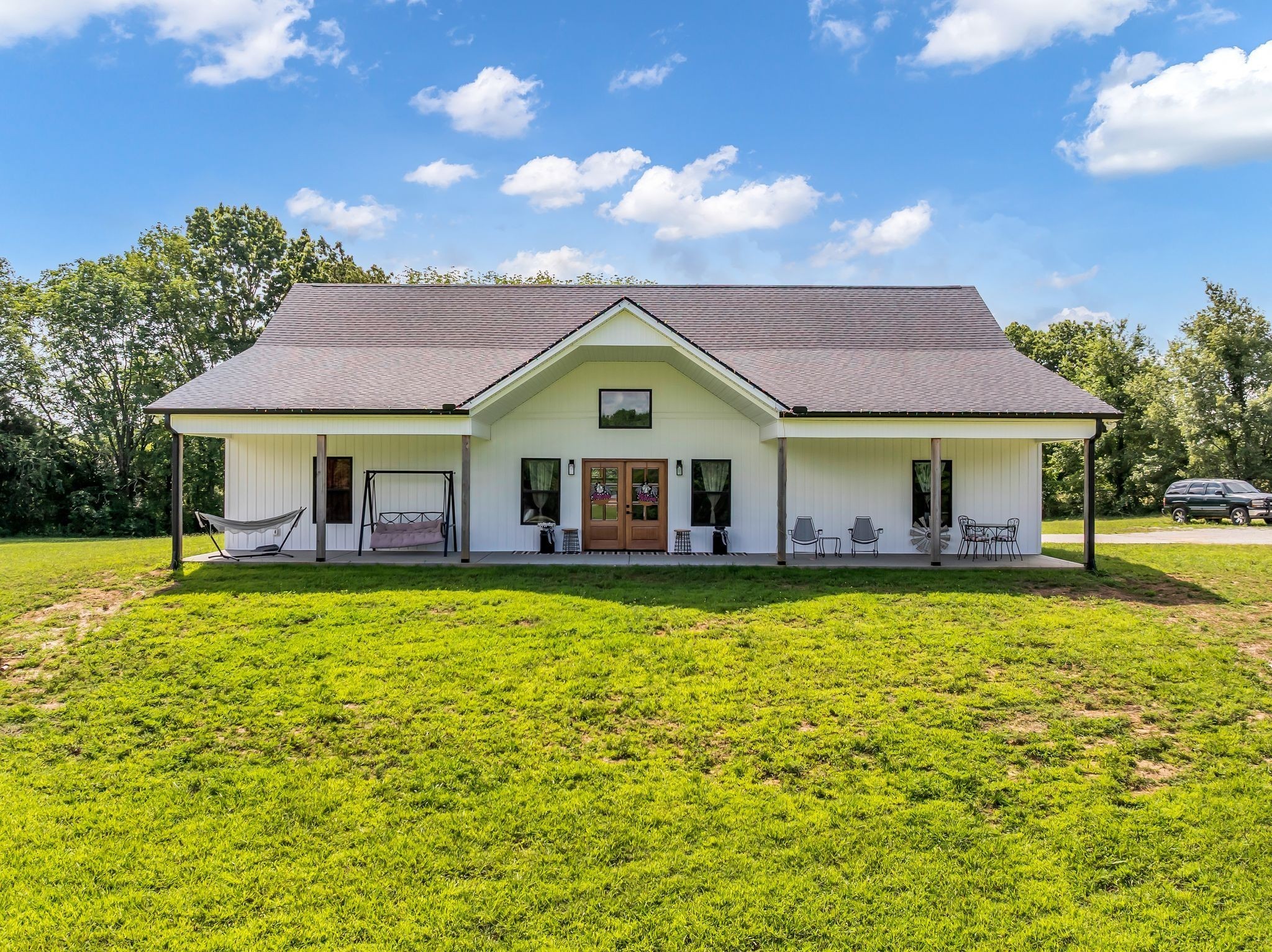 454 Gum Branch Road Burns, TN 37029 - Photo 1 of 27 a front view of a house with swimming pool having outdoor seating