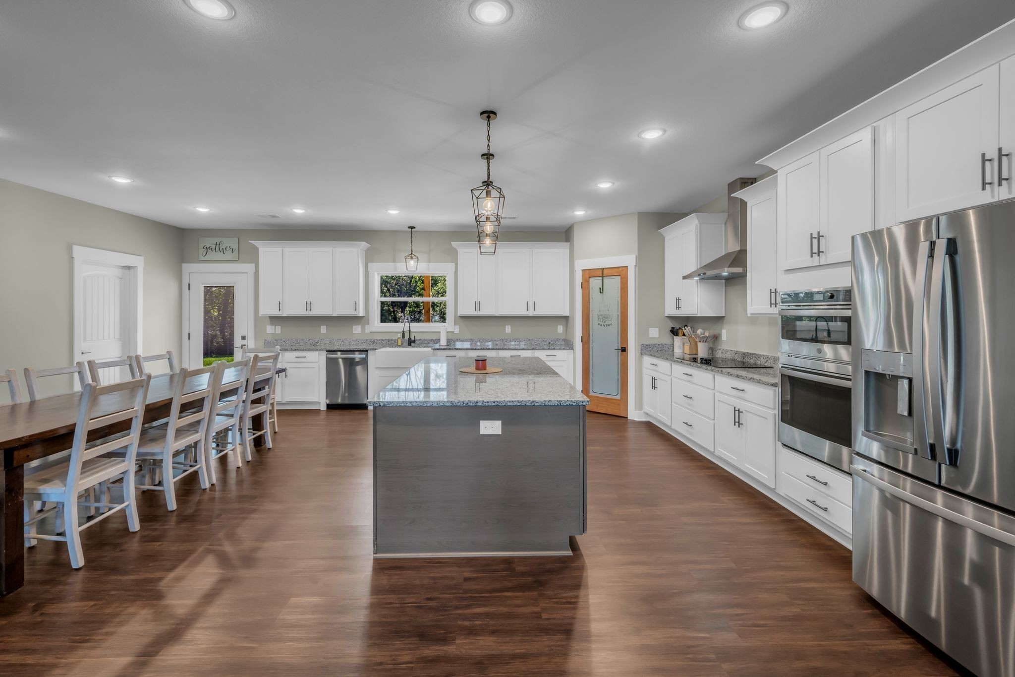 454 Gum Branch Road Burns, TN 37029 - Photo 14 of 27 a large kitchen with stainless steel appliances lots of counter space and wooden floors