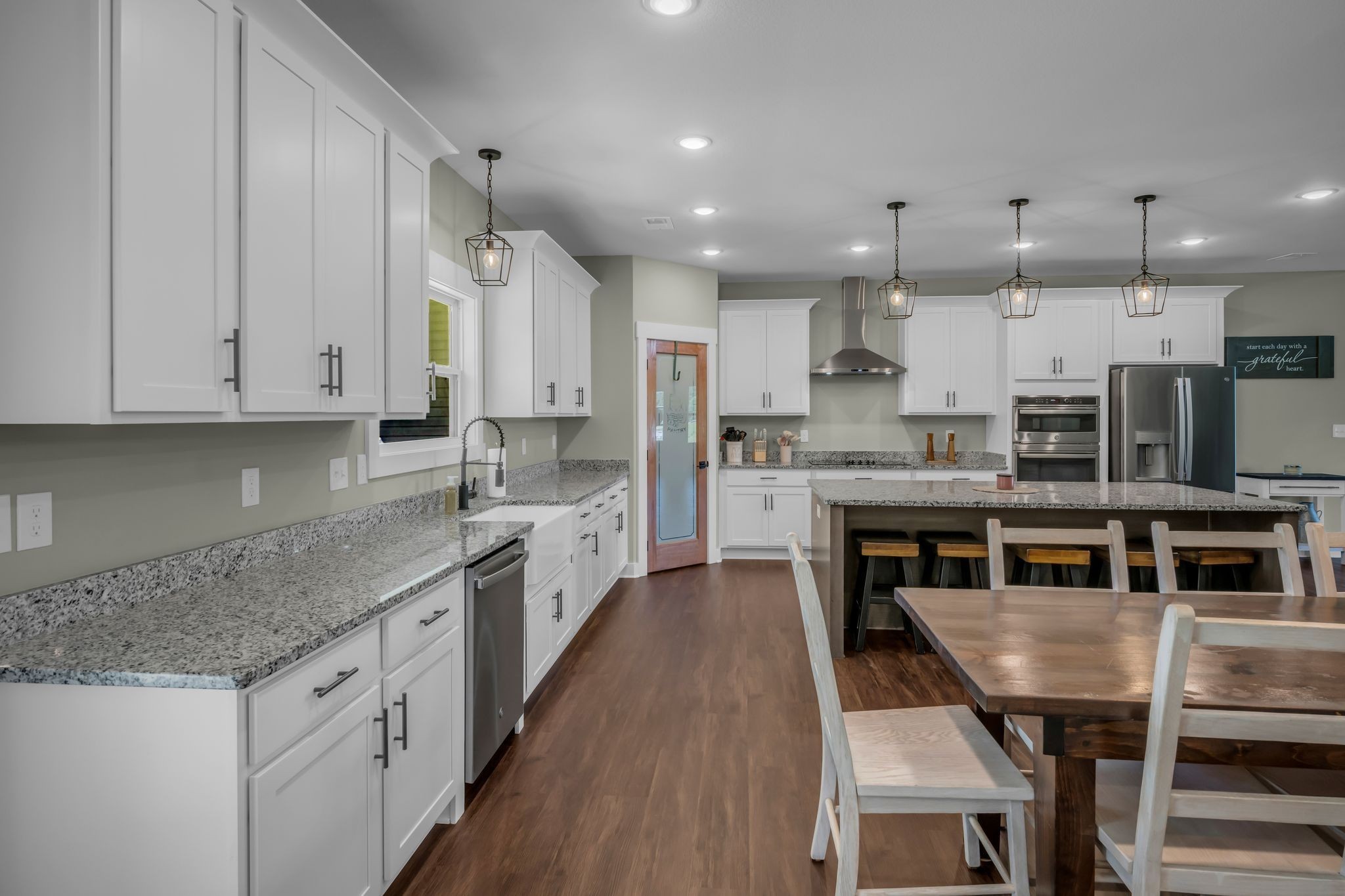 454 Gum Branch Road Burns, TN 37029 - Photo 17 of 27 a large kitchen with stainless steel appliances granite countertop a stove a sink a microwave and a refrigerator