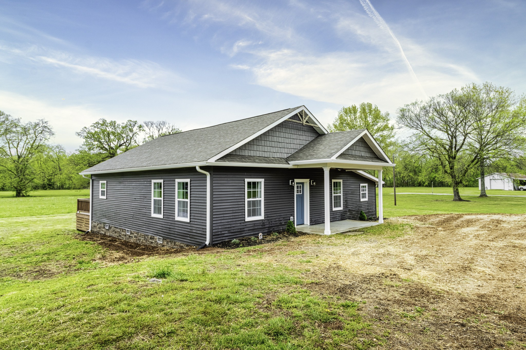 a view of a house with yard and a garden
