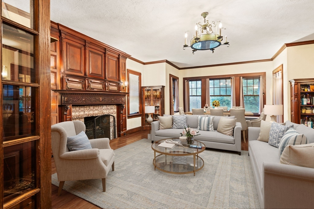 660 South Street Needham, MA 02492 - Photo 5 of 23 a living room with furniture a chandelier and a fireplace