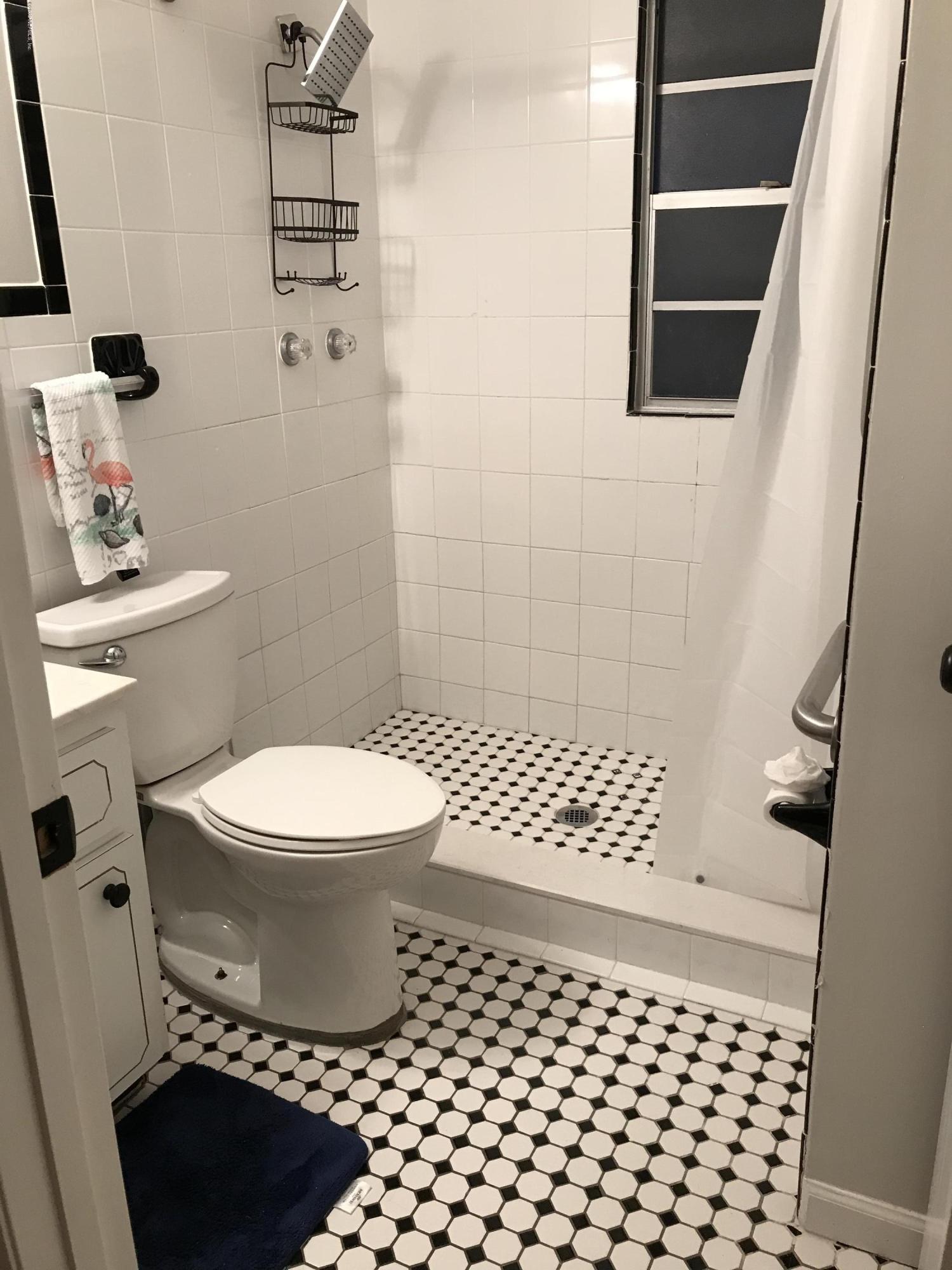 4736 Cambridge Road Jacksonville, FL 32210 - Photo 15 of 15 a bathroom with a toilet a sink and a shower