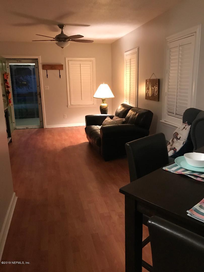 4736 Cambridge Road Jacksonville, FL 32210 - Photo 5 of 15 a living room with furniture and a window