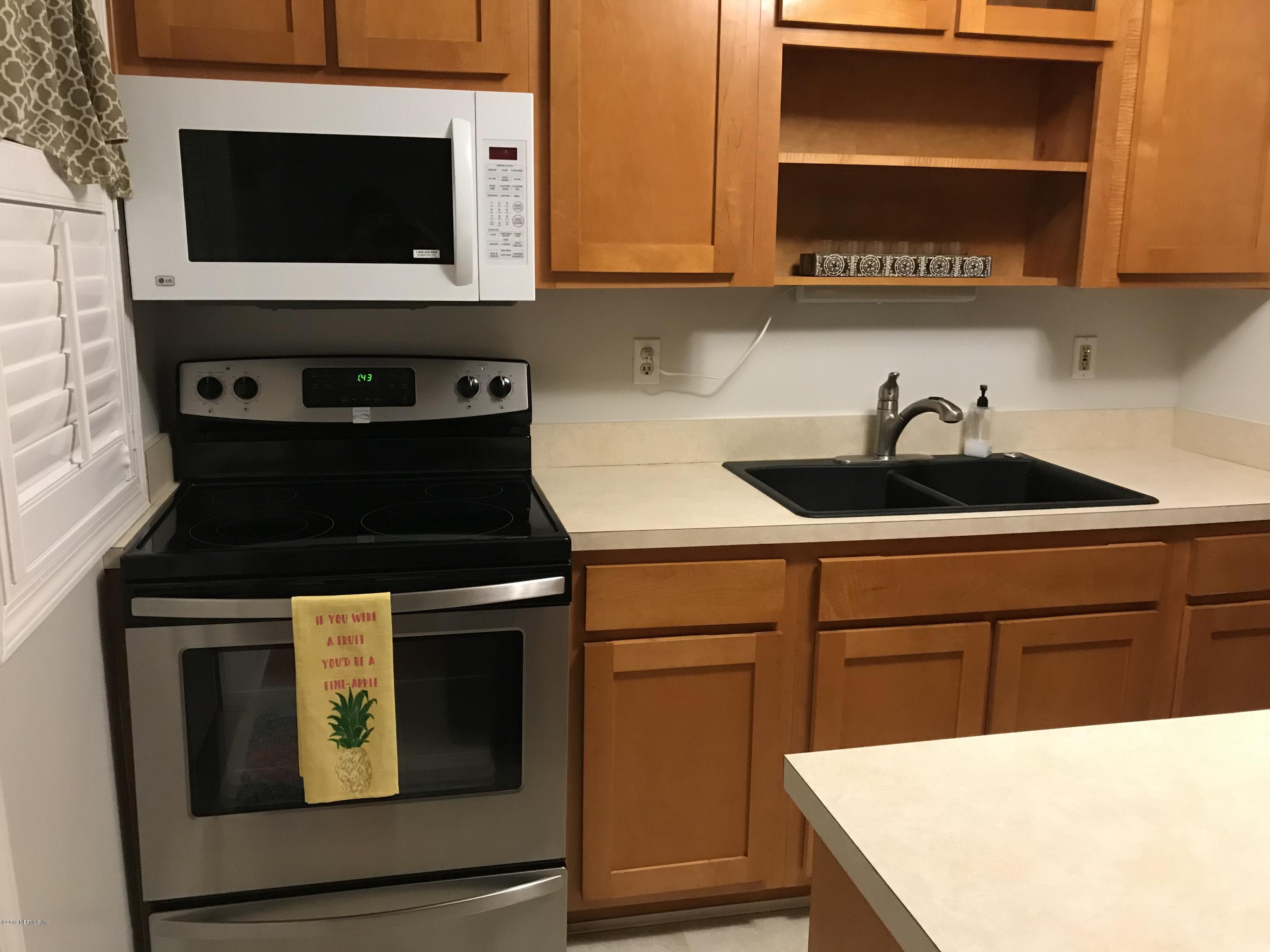 4736 Cambridge Road Jacksonville, FL 32210 - Photo 6 of 15 a kitchen with a stove and a microwave