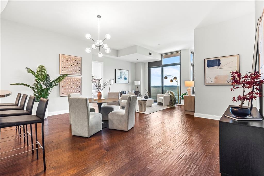 a living room with furniture dining table and a flat screen tv