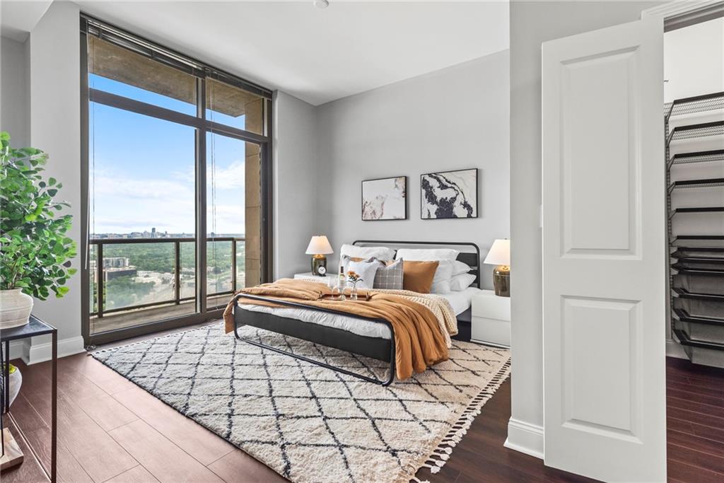 270 17th Street Northwest, Unit 4306 Atlanta, GA 30363 - Photo 14 of 54 a bedroom with a bed lamp and window