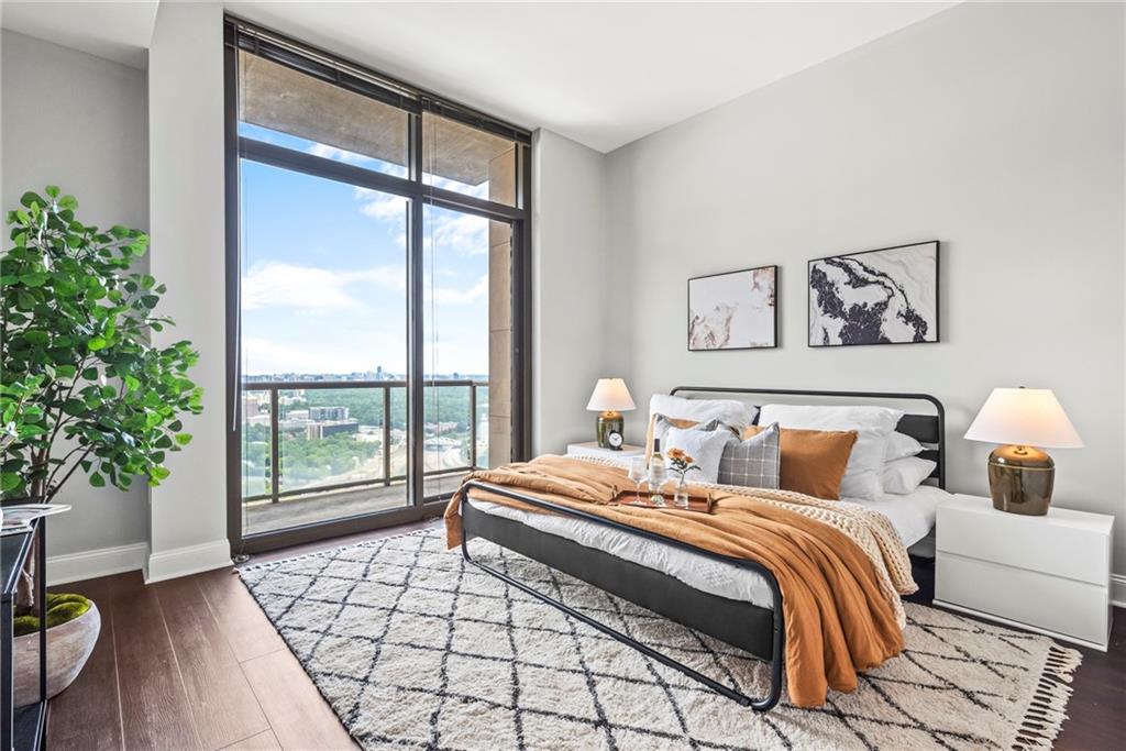270 17th Street Northwest, Unit 4306 Atlanta, GA 30363 - Photo 15 of 54 a bedroom with a large bed and a large window