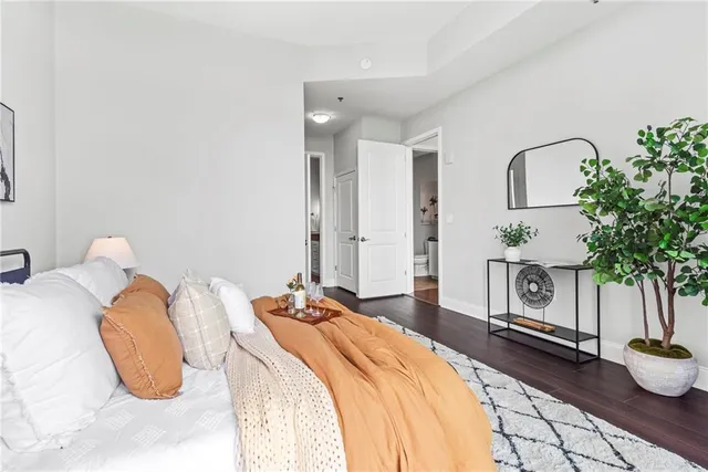 a bathroom with a granite countertop sink a toilet and a mirror