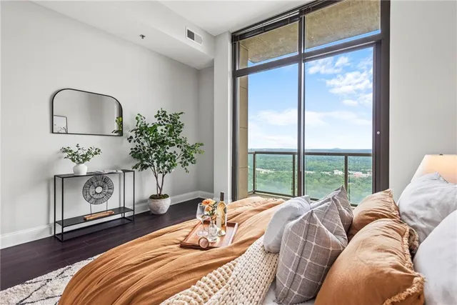 a view of a patio with couches and a table and chairs with wooden floor