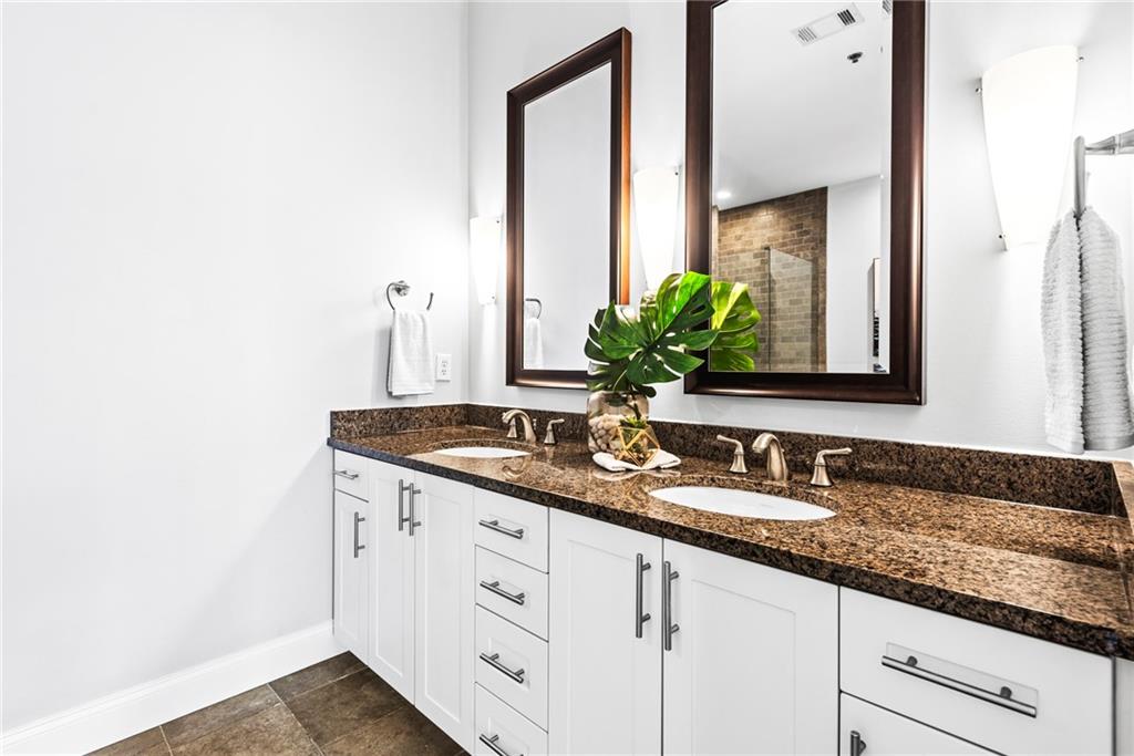 270 17th Street Northwest, Unit 4306 Atlanta, GA 30363 - Photo 19 of 54 a bathroom with a granite countertop sink and a mirror
