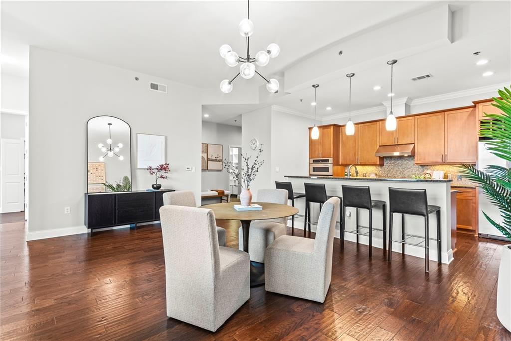 270 17th Street Northwest, Unit 4306 Atlanta, GA 30363 - Photo 4 of 54 a living room with couches kitchen view and large windows
