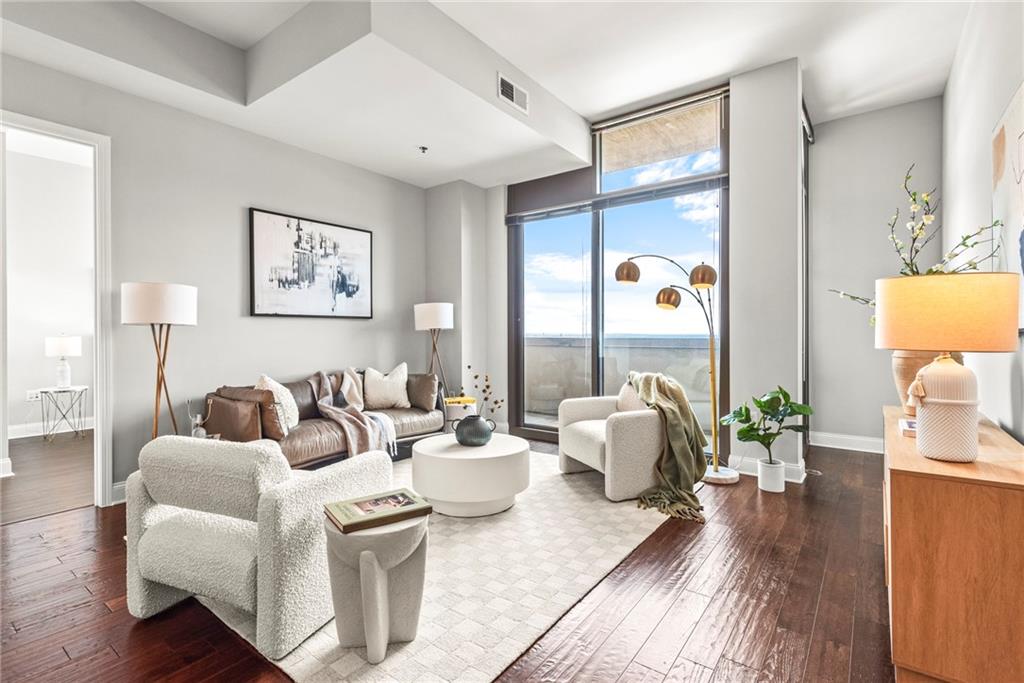 270 17th Street Northwest, Unit 4306 Atlanta, GA 30363 - Photo 6 of 54 a living room with furniture and wooden floor